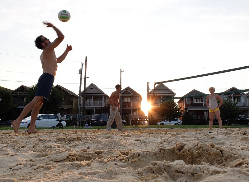 Casey Smith, left, Zack Umbarger and Abi Wright play volleyball one recent evening on the Jefferson Heights Park court in the 1800 block of Jefferson St., a newly gentrified neighborhood in Chattanooga's Southside.