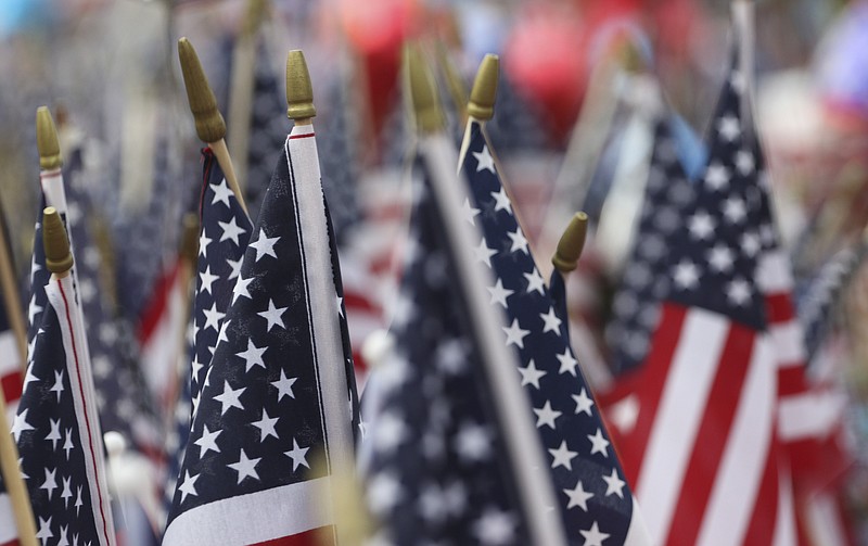 Notes, trinkets and flags line the parking lot where a memorial had been set up in memory of the military personnel gunned down on July 16 in Chattanooga.