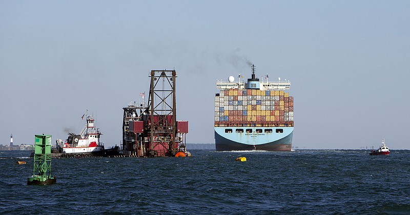 
              The container ship Maersk Karlskrona, right, sails up river past the 300-foot dredge Alaska as it deepens the shipping channel to the port of Savannah off the coast of Tybee Island, Ga., Monday, Sept. 14, 2015. The U.S. Army Corps of Engineers and the Georgia Ports Authority started the dredging the channel five days ago. The $706 million project, first authorized by Congress in 1999, will deepen the shipping channel traveled by cargo ships along 39 miles of the Savannah River.  (AP Photo/Stephen B. Morton)
            