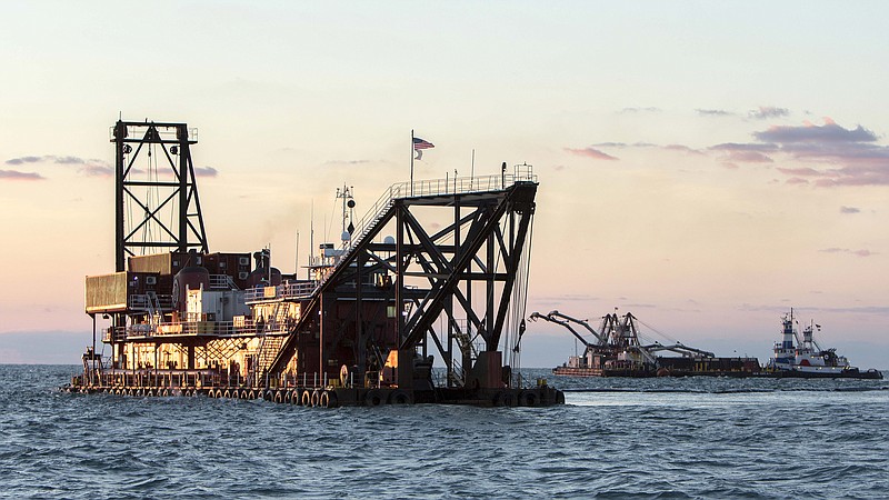 The 300-foot Great Lakes Dredge and Dock dredge Alaska, left, and spider barge work together to deepen the shipping channel to the port of Savannah off the coast of Tybee Island, Ga., Monday, Sept. 14, 2015. The U.S. Army Corps of Engineers and the Georgia Ports Authority started the dredging the channel five days ago. The $706 million project, first authorized by Congress in 1999, will deepen the shipping channel traveled by cargo ships along 39 miles of the Savannah River. (AP Photo/Stephen B. Morton)
