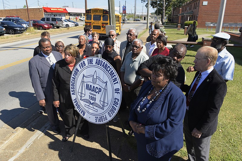 Dr. Elenora Woods, foreground right, president of the Chattanooga Hamilton County NCAAP, speaks at a news conference on the sidewalk in front of the East Lake Courts on Tuesday, Sept. 15, 2015, in Chattanooga, Tenn. 