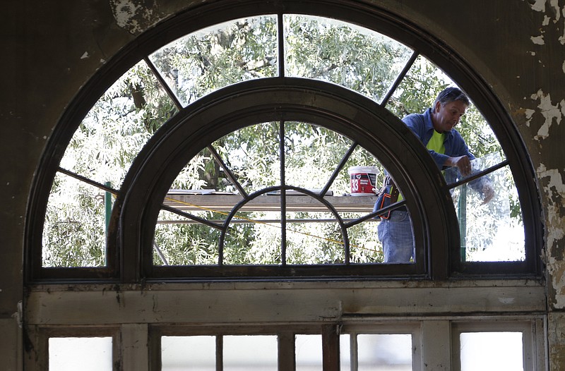 Monty Eachus installs new glass on what will be the main entrance as construction continues on Tuesday, September 15, 2015 at the new restaurant STIR located in the historic Chattanooga ChooChoo building. 