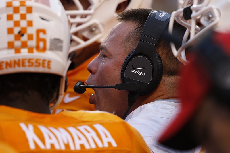 UT head coach Butch Jones huddles with his team while during a time out from playing Oklahoma during the first half of play Saturday. The Volunteers played the Sooner's at home on Sept.12, 2015, at Neyland Stadium in Knoxville.