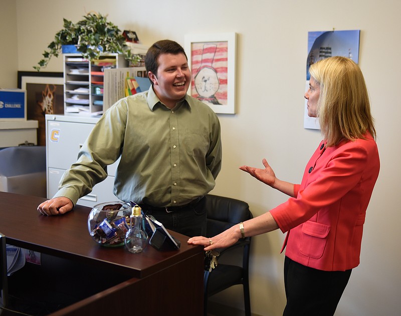 Staff photo by John Rawlston/Chattanooga Times Free Press - Margaret Brockman, right, department head of the College of Business at UTC, talks with recent graduate Andrew Byrum on campus. Byrum is founder and president of Get Seated, a company that operates a smart phone app that helps customers manage wait times at restaurants.