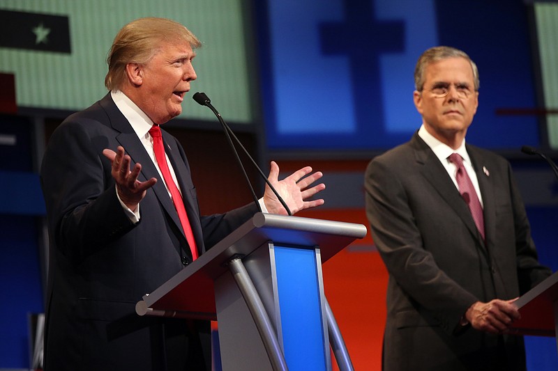 
              FILE - In this Aug. 6, 2015, file photo Republican presidential candidate Donald Trump speaks as Jeb Bush watches during a Republican presidential debate in Cleveland. Eleven top-tier Republican presidential hopefuls face off in their second prime-time debate of the 2016 campaign Sept. 16, in a clash between outsiders and establishment candidates under a cathedral of political conservatism.   (AP Photo/Andrew Harnik, File)
            