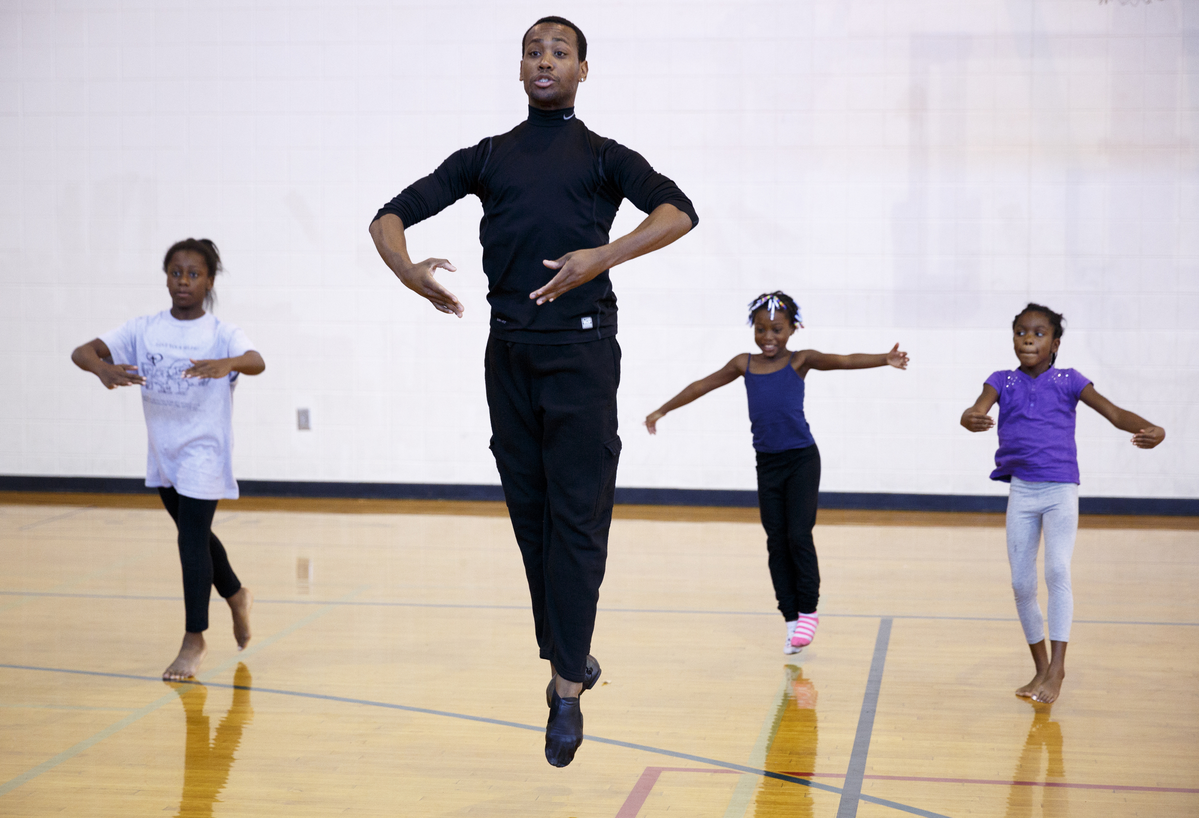 Fred Davis leads dance students across the gymnasium floor during a master class at Brainerd Recreation Center. Davis, a Chattanooga native and Center for Creative Arts graduate, is a professional dancer living in New York City.
