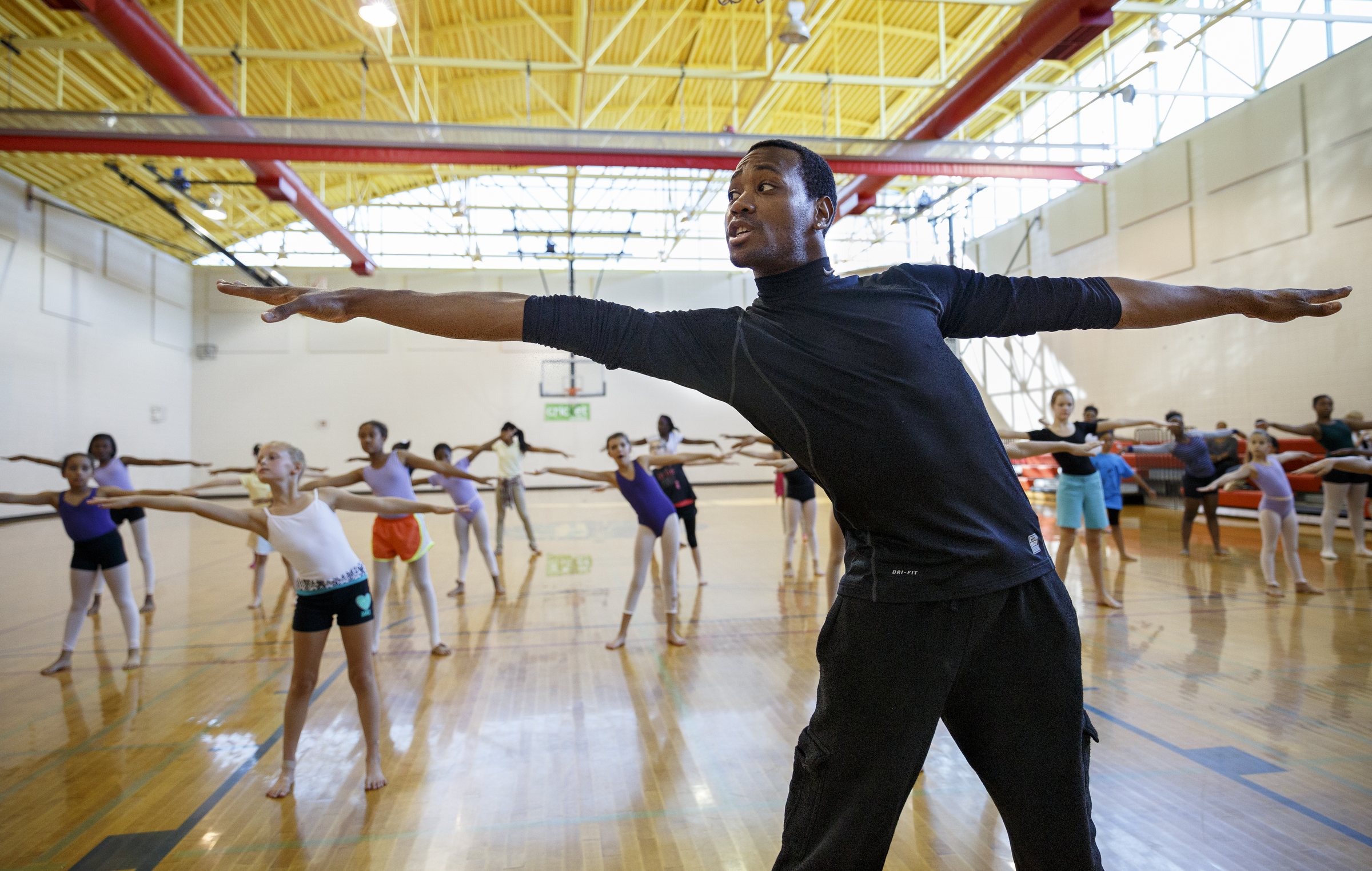 Professional dancer Fred Davis leads students in warmups during a master class at the Brainerd Recreation Center.