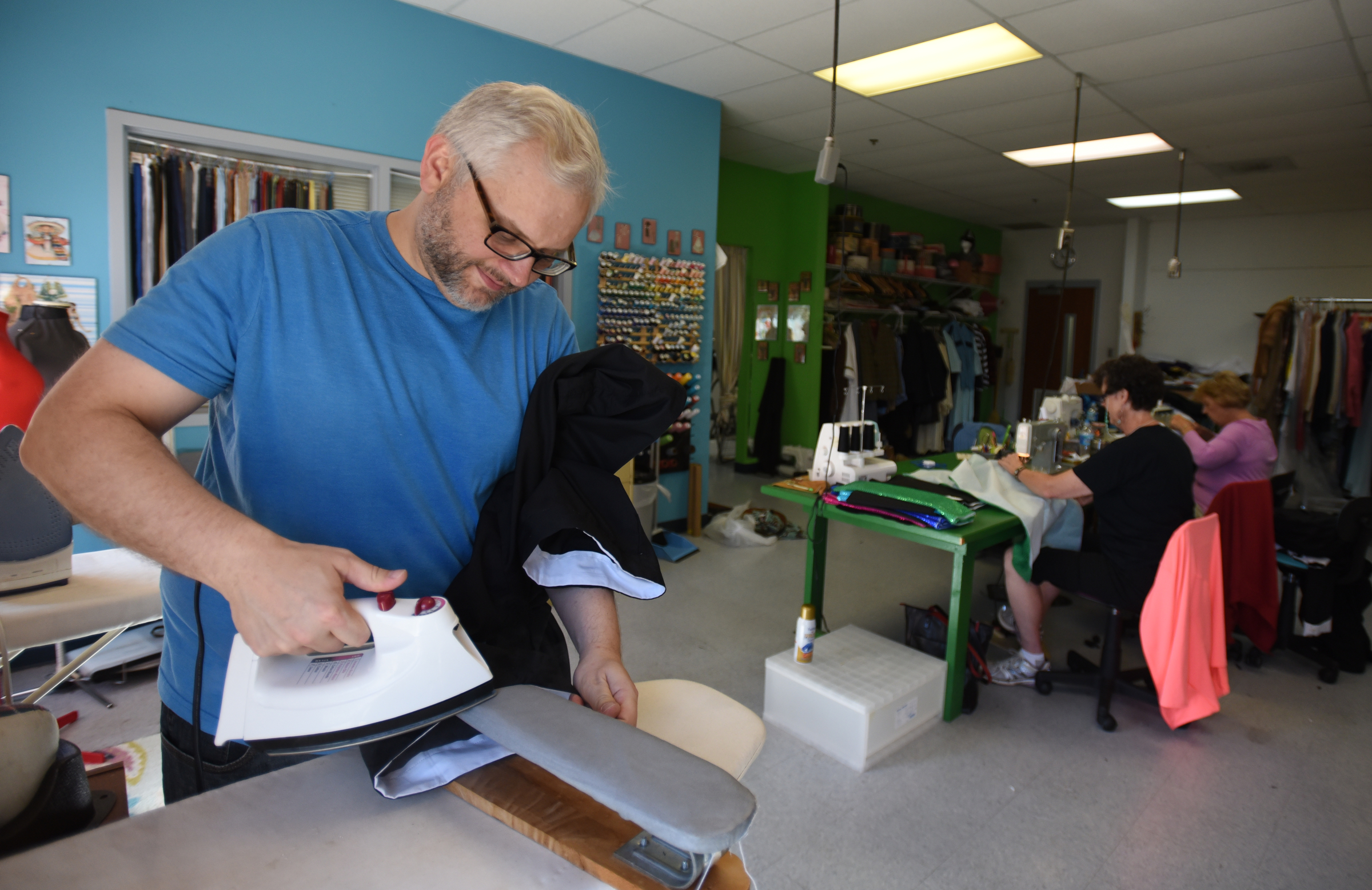 "Sister Act" director and costumer designer Scott Dunlap irons a nun costume at the Chattanooga Theatre Centre.