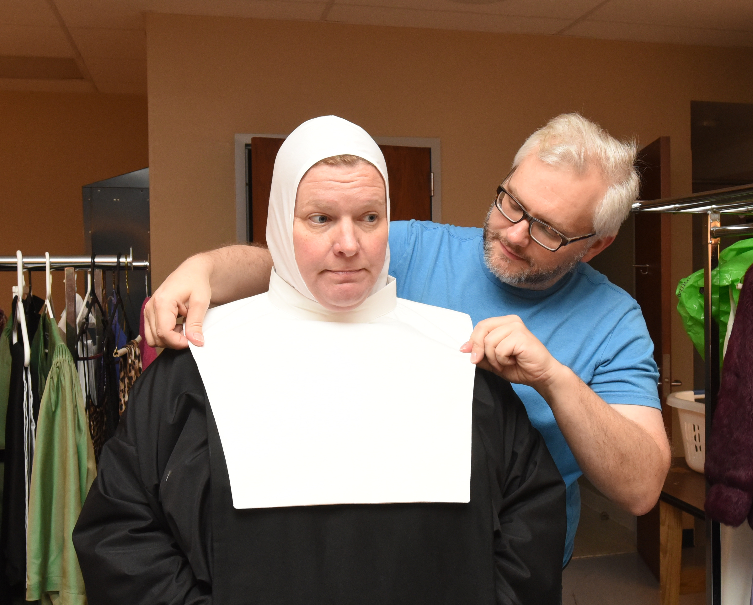 Here, Scott Dunlap helps Gumnick with the wimple, also known as a guimpe, the white-fabric piece that surrounds the nun's face and neck and covers her shoulders and upper chest.