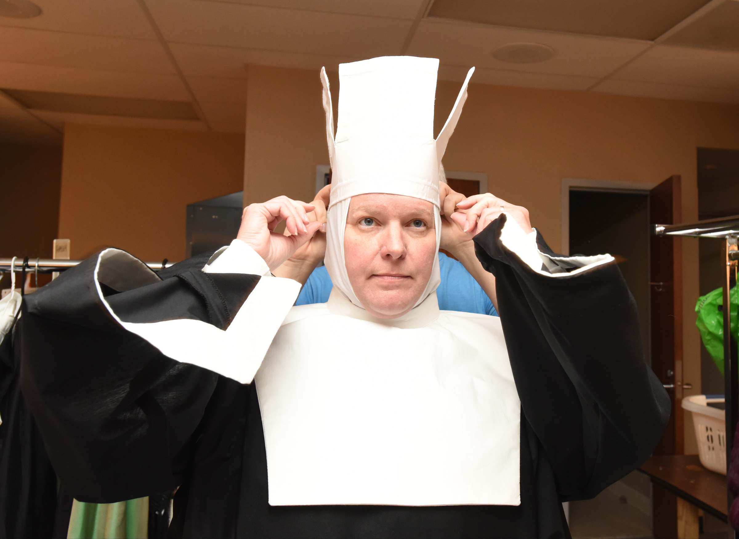 Dunlap is placing what he calls "origami with fabric," part of the coif, or headress, for nuns. The standing-up parts will be folded down.