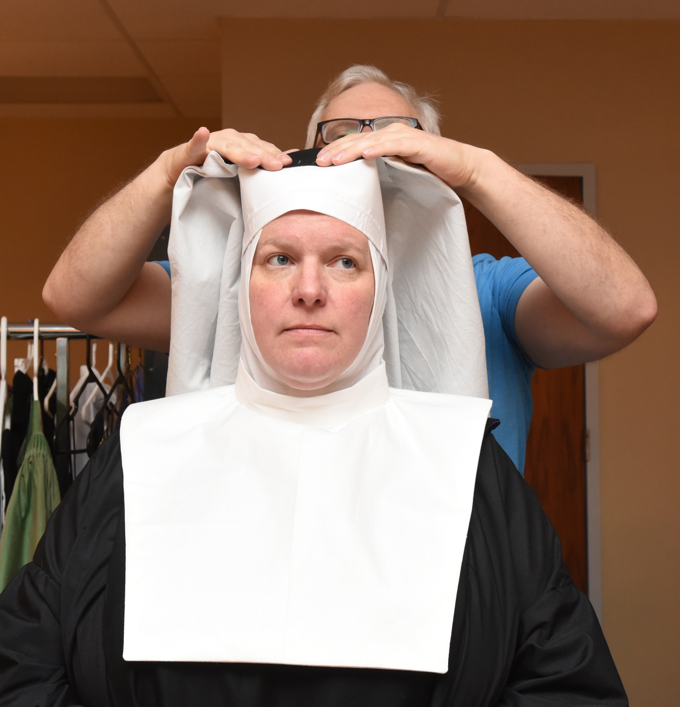 Satisfied with the coif, Dunlap begins to attach the veil, which will hang down on the sides and back of the head.