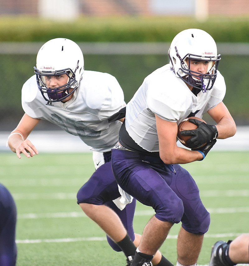 Sequatchie County running back Brandon Rudd, right, and quarterback Houston Mainord, left, have helped the Indians start 4-0 for the first time since 1996. Coach Adam Caine, who's in his first season leading the program, is working to keep his team focused on the opponent at hand.