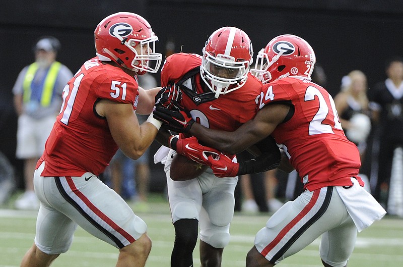 Georgia's Jake Ganus (51), Reggie Wilkerson (9) and Dominick Sanders (24) all came away with interceptions last week in the 31-14 win at Vanderbilt.