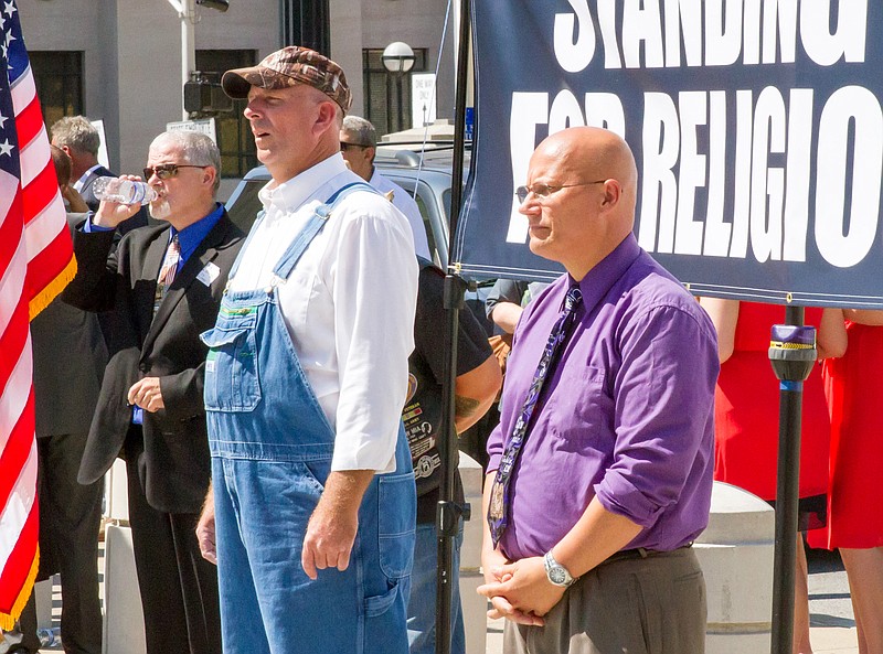 Joe Davis, husband of Kentucky clerk Kim Davis, left, and pastor Randy Smith attend a rally of conservative Christians in Nashville, Tenn., on Thursday, Sept. 17, 2015. Davis only briefly addressed the crowd to thank them for attending. (AP Photo/Travis Loller)