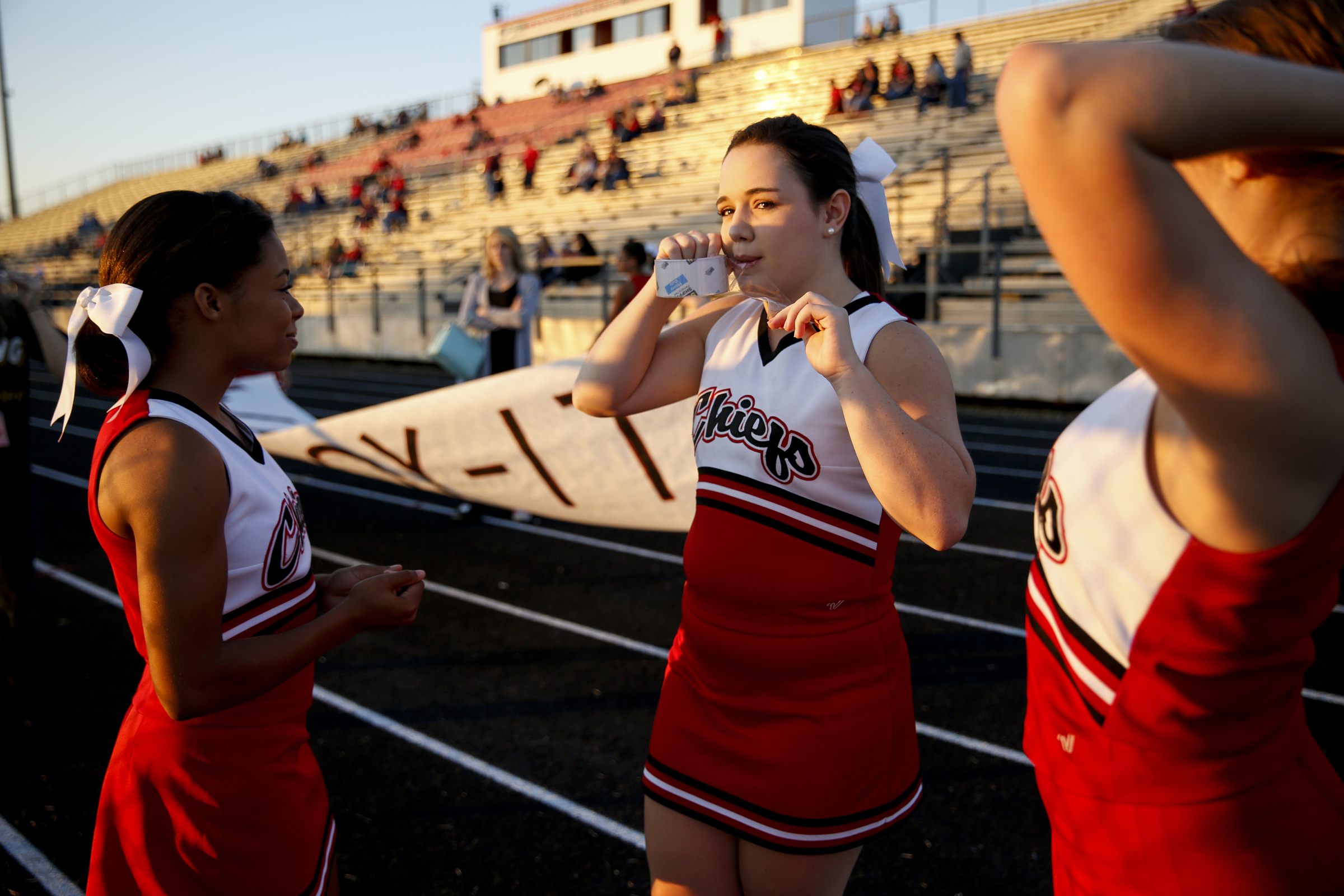 North Jackson cheerleaders Akira Hutchins, Courtney Watson, and Holly Summers prepare for their prep football game against DAR at North Jackson High School on Thursday, Sept. 17, 2015, in Stevenson, Ala.
