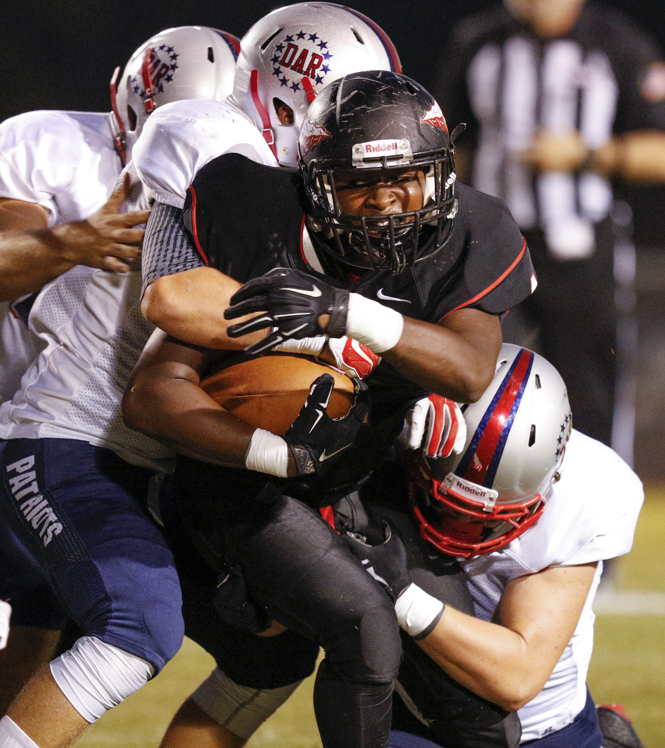 North Jackson running back Omar Brown is tackled by a group of DAR defenders during their prep football game against DAR at North Jackson High School on Thursday, Sept. 17, 2015, in Stevenson, Ala.