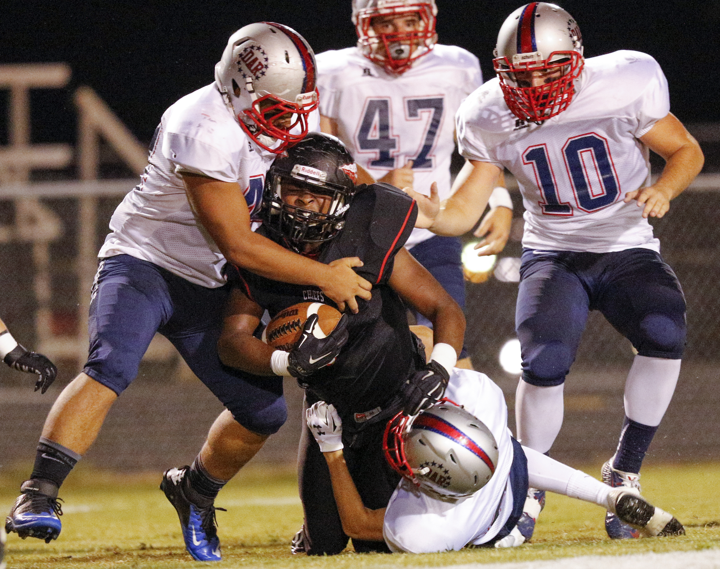 North Jackson running back Omar Brown is tackled by a group of DAR defenders during their prep football game against DAR at North Jackson High School on Thursday, Sept. 17, 2015, in Stevenson, Ala.