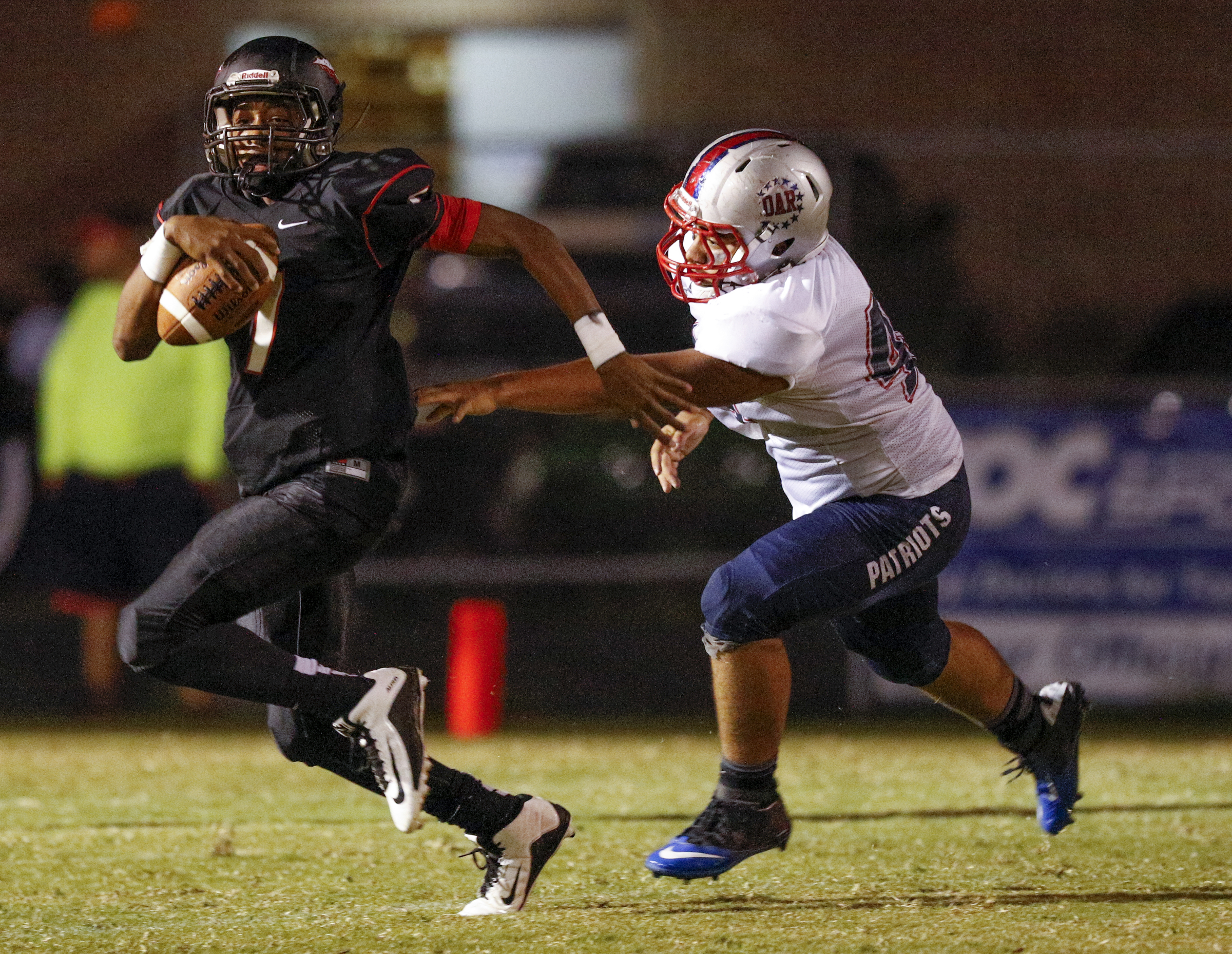 North Jackson running back Trey Harris breaks around DAR defender Bryce Fowler during their prep football game against DAR at North Jackson High School on Thursday, Sept. 17, 2015, in Stevenson, Ala.