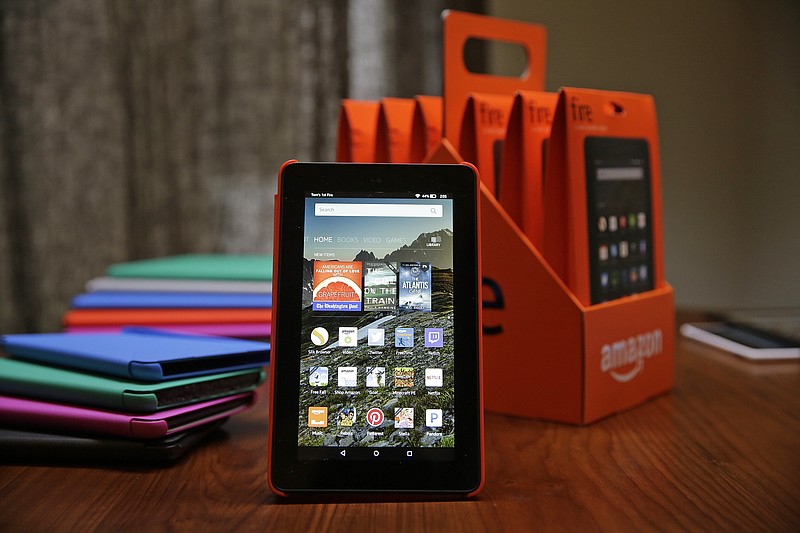 
              In this Wednesday, Sept. 16, 2015, photo, Amazon's new $50 Fire tablet is displayed next to a six-pack of them and assorted colored cases in San Francisco. Amazon.com is introducing the $50 tablet computer in its latest attempt to boost its online store sales by luring consumers who can’t afford more expensive Internet-connected devices made by Apple and other rivals. (AP Photo/Eric Risberg)
            