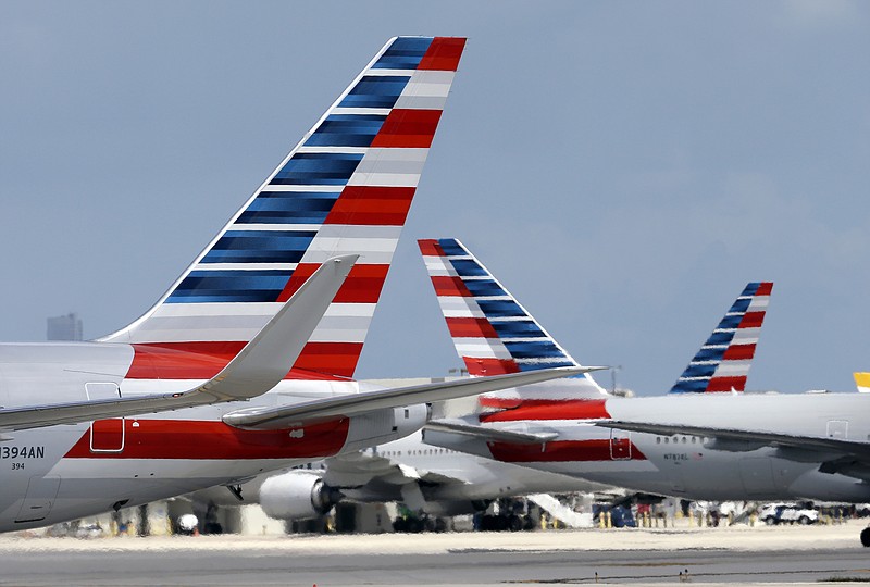 
              FILE - In this May 27, 2015 file photo, American Airlines aircraft taxi at Miami International Airport, in Miami. American Airlines says it has fixed a technology problem that was grounding flights to and from Dallas, Chicago and Miami on Thursday, Sept. 17, 2015. (AP Photo/Lynne Sladky, File)
            