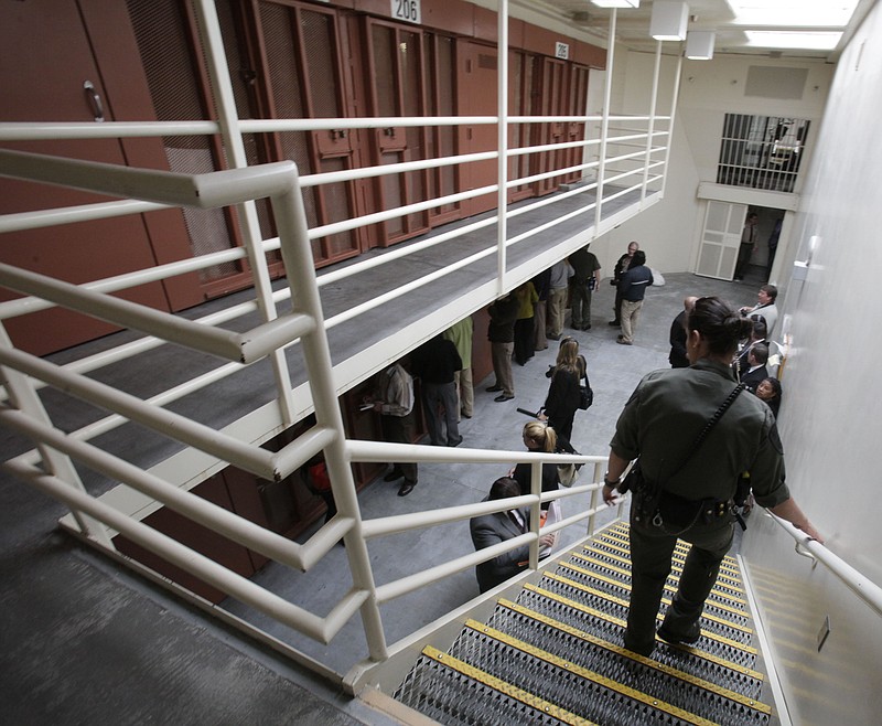 
              FILE -- In this Aug. 17, 2011 file photo, reporters inspect one of the two-tiered cell pods in the Security Housing Unit at the Pelican Bay State Prison near Crescent City, Calif. Inmates say newly imposed welfare checks in the SHU have created excessive noise by the guards, causing California prison officials to hand out earplugs to inmates and tell the guards to walk softly while going about their rounds.(AP Photo/Rich Pedroncelli, file)
            