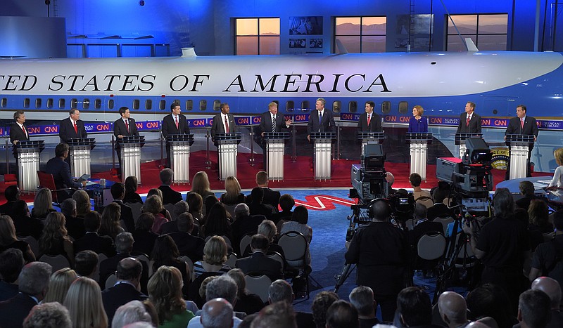 Republican presidential candidate, businessman Donald Trump, center, speaks as the other candidates look on during the CNN Republican presidential debate at the Ronald Reagan Presidential Library and Museum on Wednesday, Sept. 16, 2015, in Simi Valley, Calif. 