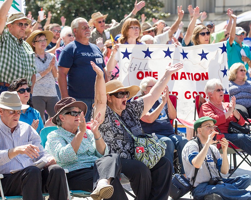 Members of the crowd cheer during a Christian conservatives rally outside the Tennessee Capitol on Thursday, Sept. 17, 2015, in Nashville. The event featured Joe Davis, the husband of Kentucky clerk Kim Davis, and Rafael Cruz, the father of U.S. Sen. Ted Cruz, a Republican presidential candidate. (AP Photo/Erik Schelzig)