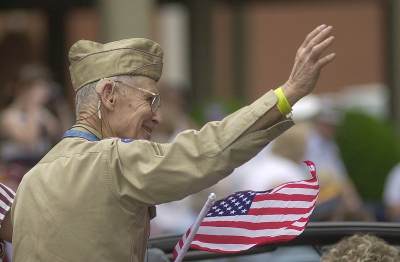 Medal of Honor winner and World War II veteran Desmond Doss waves to spectators during an Armed Forced parade.
