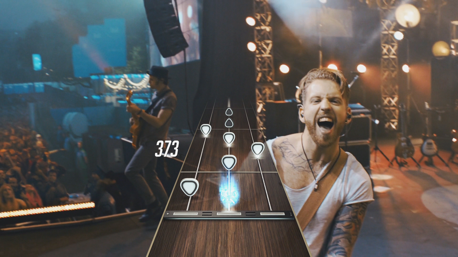 In the GHLive mode of "Guitar Hero Live," players will view the performance from the perspective of the band via live action video. Based on their performance, bandmates and the crowd will respond dynamically to how well or poorly the player is doing. [Contributed image.]