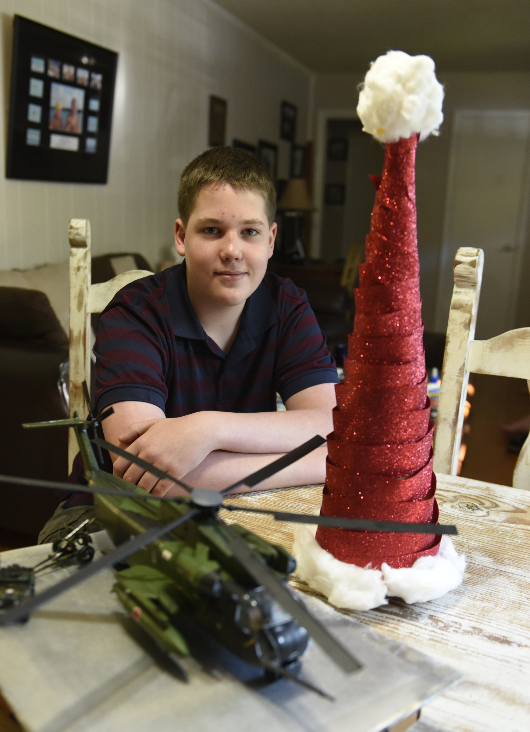 Cooper Plotner is photographed on Thursday, Sept. 17, 2015, at his home in Soddy-Daisy, Tenn., with a model helicopter and a Christmas decoration he made, two of his entries in the upcoming Hamilton County Fair.