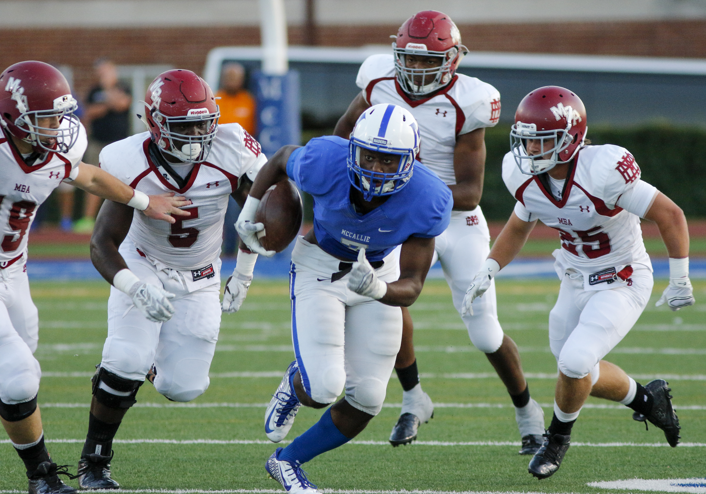 McCallie's Tynelius Hall runs the ball ahead of a pack of MBA defenders during the tornados' prep football game against Montgomery Bell Academy at McCallie School on Friday, Sept. 18, 2015, in Chattanooga, Tenn.