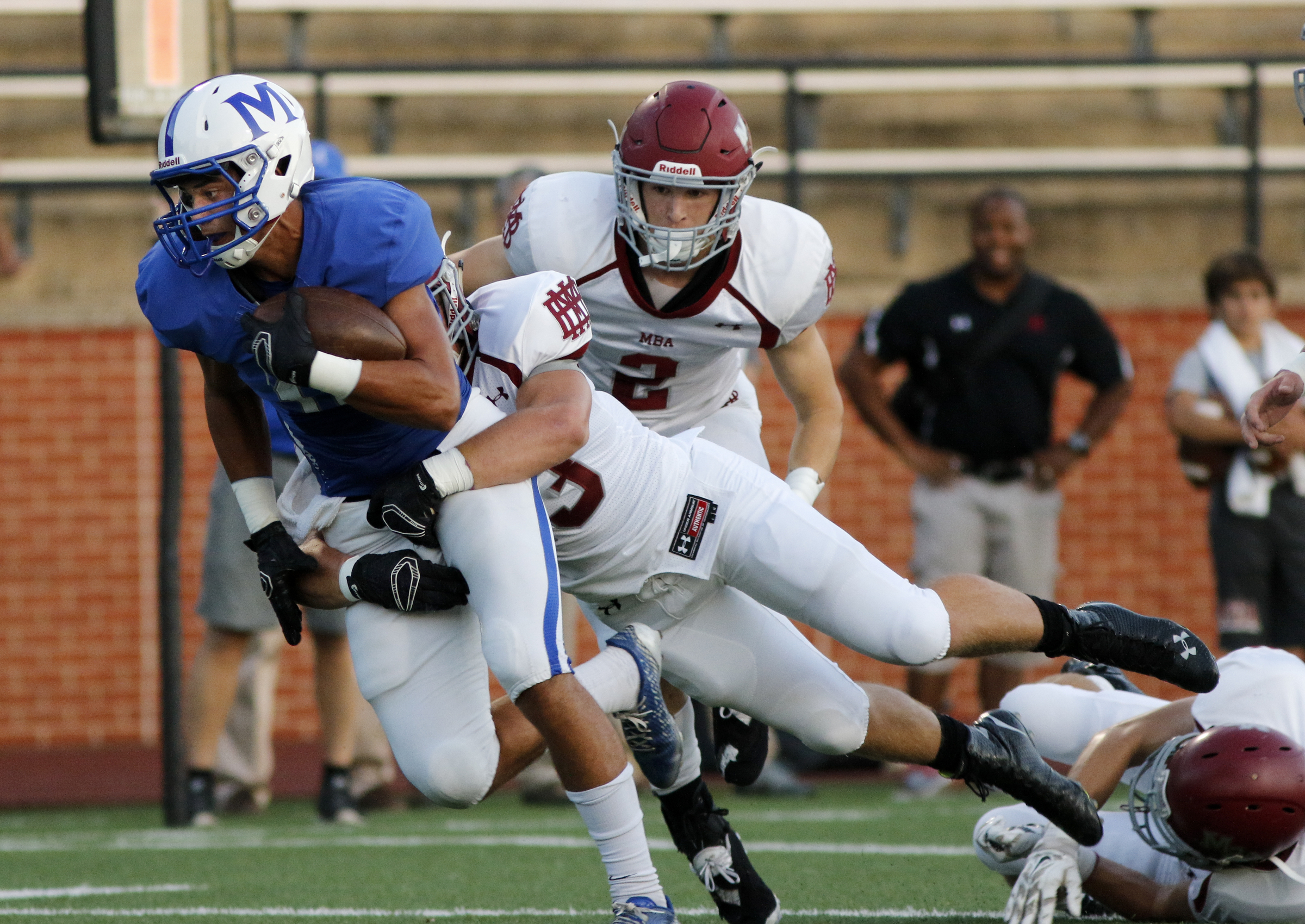 McCallie's Walker Fannon is tackled by MBA's Sam Sullivan for a first down during the tornados' prep football game against Montgomery Bell Academy at McCallie School on Friday, Sept. 18, 2015, in Chattanooga, Tenn.