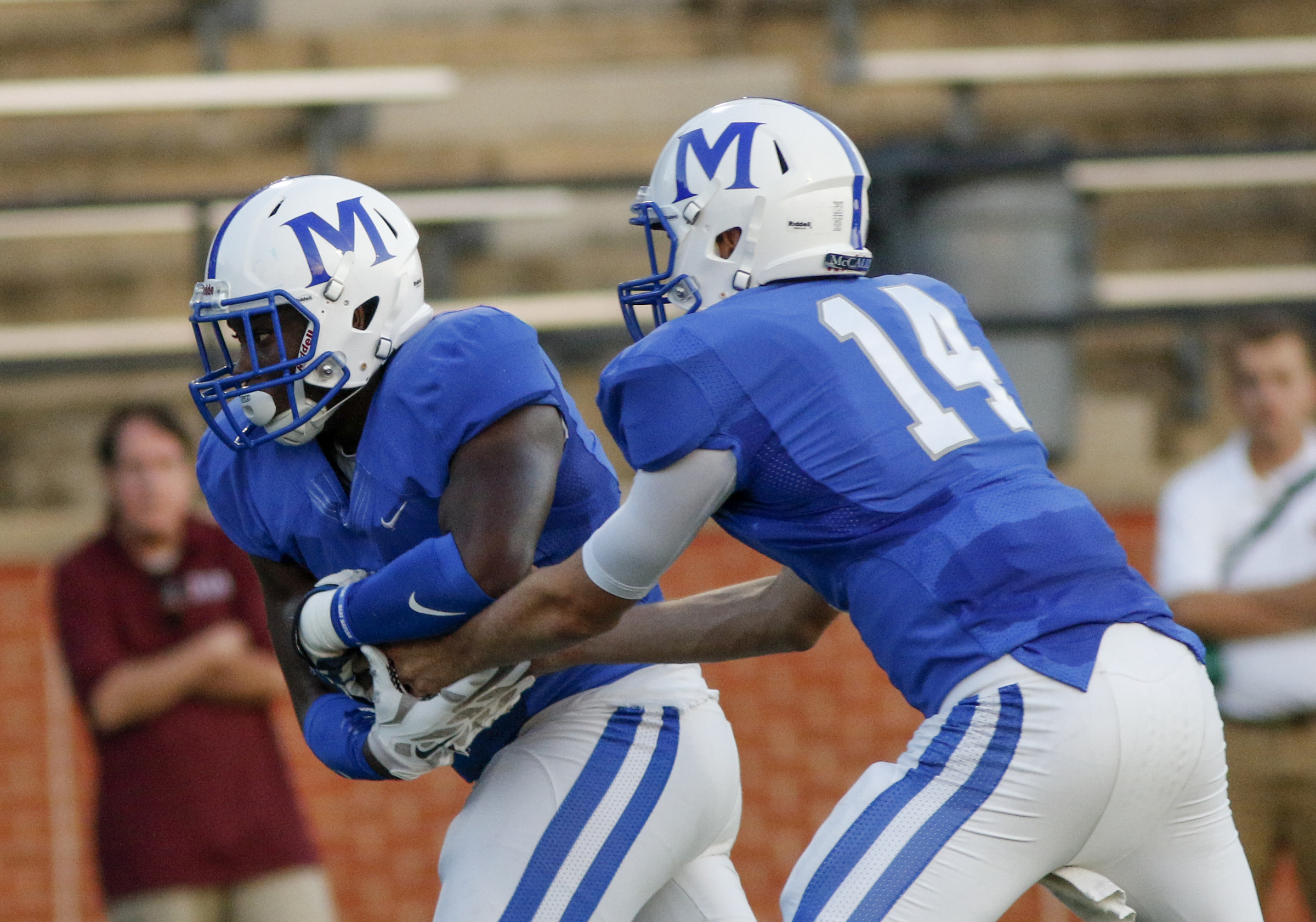 McCallie quarterback Robert Riddle, right, hands the ball off to teammate Tynelius Hall during the tornados' prep football game against Montgomery Bell Academy at McCallie School on Friday, Sept. 18, 2015, in Chattanooga, Tenn.