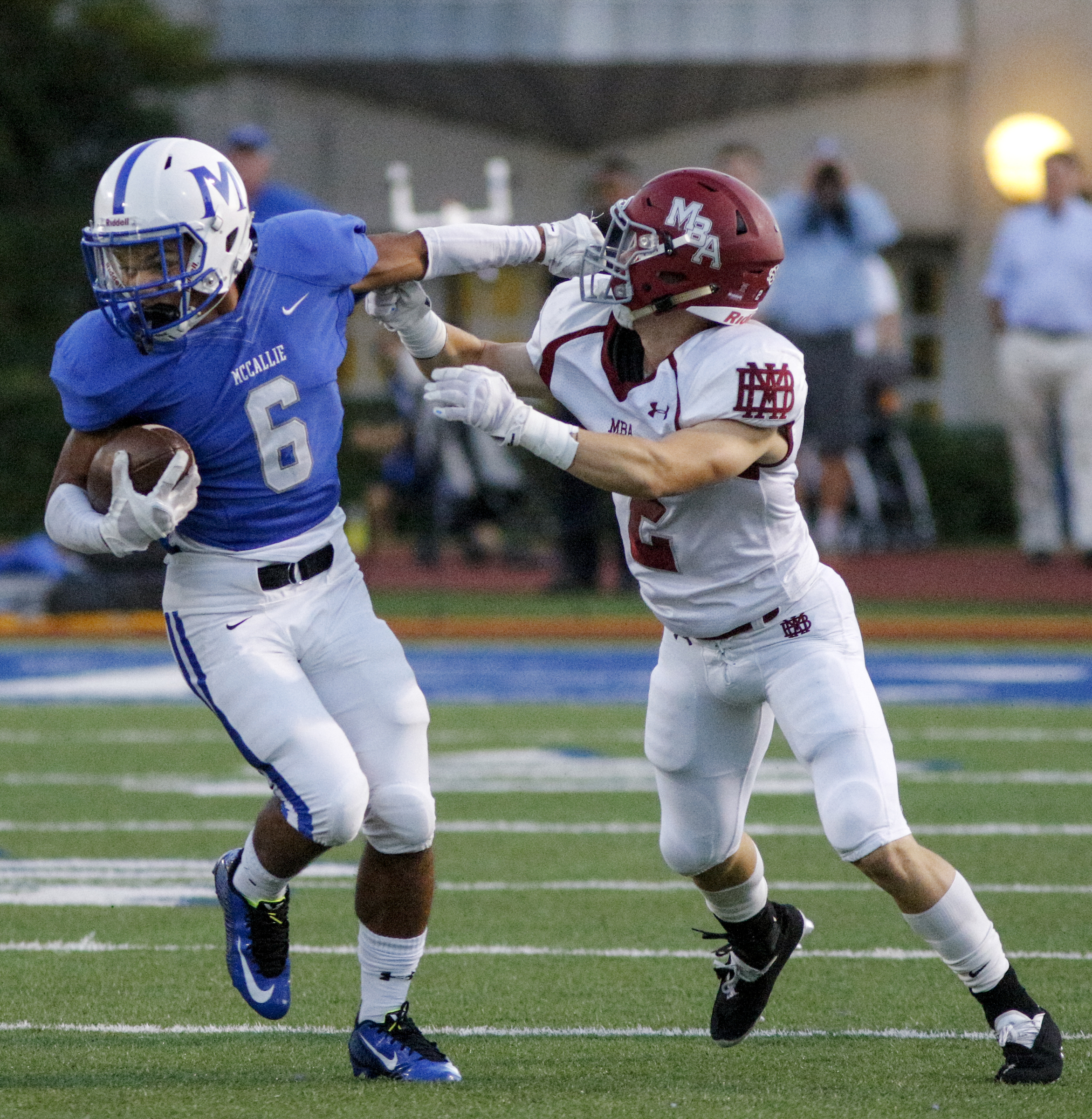 McCallie's Rico Dozier, left, stiff-arms MBA defender Montgomery Owen during the tornados' prep football game against Montgomery Bell Academy at McCallie School on Friday, Sept. 18, 2015, in Chattanooga, Tenn.