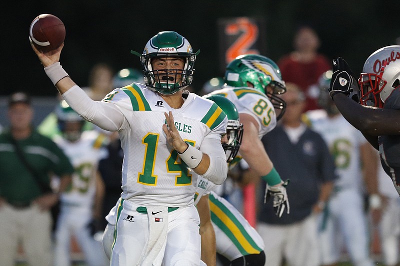 Rhea County's quarterback Daniel Dotson (14) throws the ball while playing Ooltewah during the first half of play at the Owl's home field on Friday, September 18, 2015. 