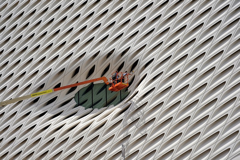
              FILE - In this Sept. 1, 2015 file photo, workers clean the facade around a window of the new Broad Museum in downtown Los Angeles. The Conference Board releases its index of leading indicators for August on Friday, Sept. 18, 2015. (AP Photo/Richard Vogel, File)
            
