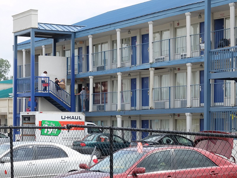 Residents continue to move out of one of two condemned buildings Thursday at the Superior Creek Lodge in East Ridge.