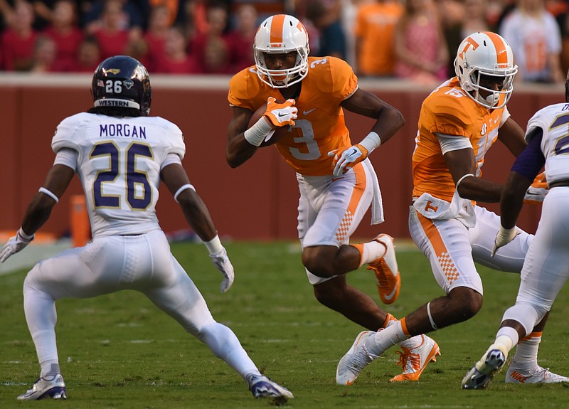 UT's Josh Malone carries as Western Carolina'sTrey Morgan approaches Saturday, September 19, 2015 at Neyland Stadium in Knoxville, Tenn.