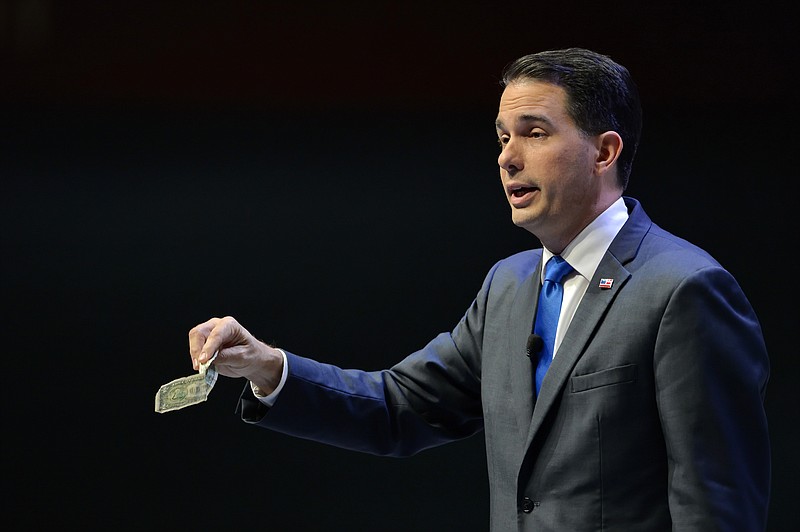 
              Republican presidential candidate Wisconsin Gov., Scott Walker speaks at a presidential forum sponsored by Heritage Action at the Bon Secours Wellness Arena, Friday, Sept. 18, 2015, in Greenville, S.C. (AP Photo/Richard Shiro)
            