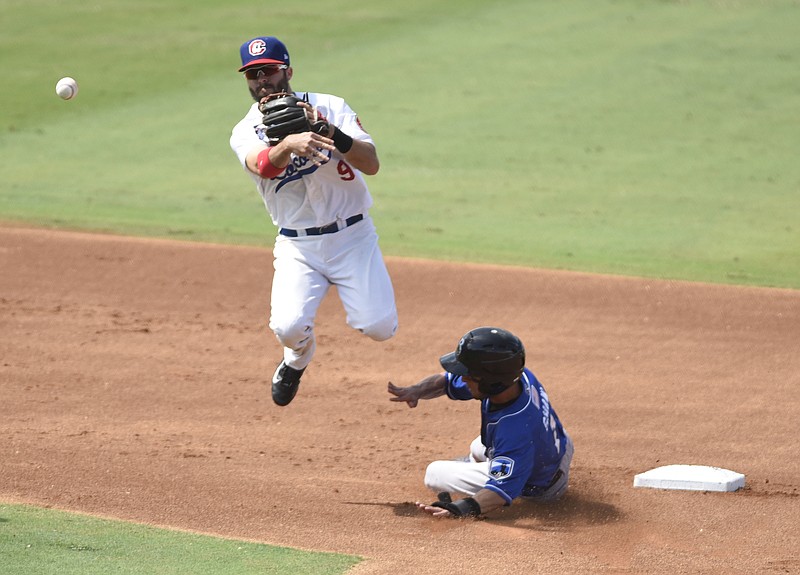 Chattanooga Lookouts shortstop Levi Michael turns a first-inning double play as he jumps over the Biloxi Shuckers' Orlando Arcia on Sunday at AT&T Field. Trailing 2-0 through 5 1/2 innings, the Lookouts scored four runs in the bottom of the sixth and made the lead stand up to win the fourth game of the best-of-five series.