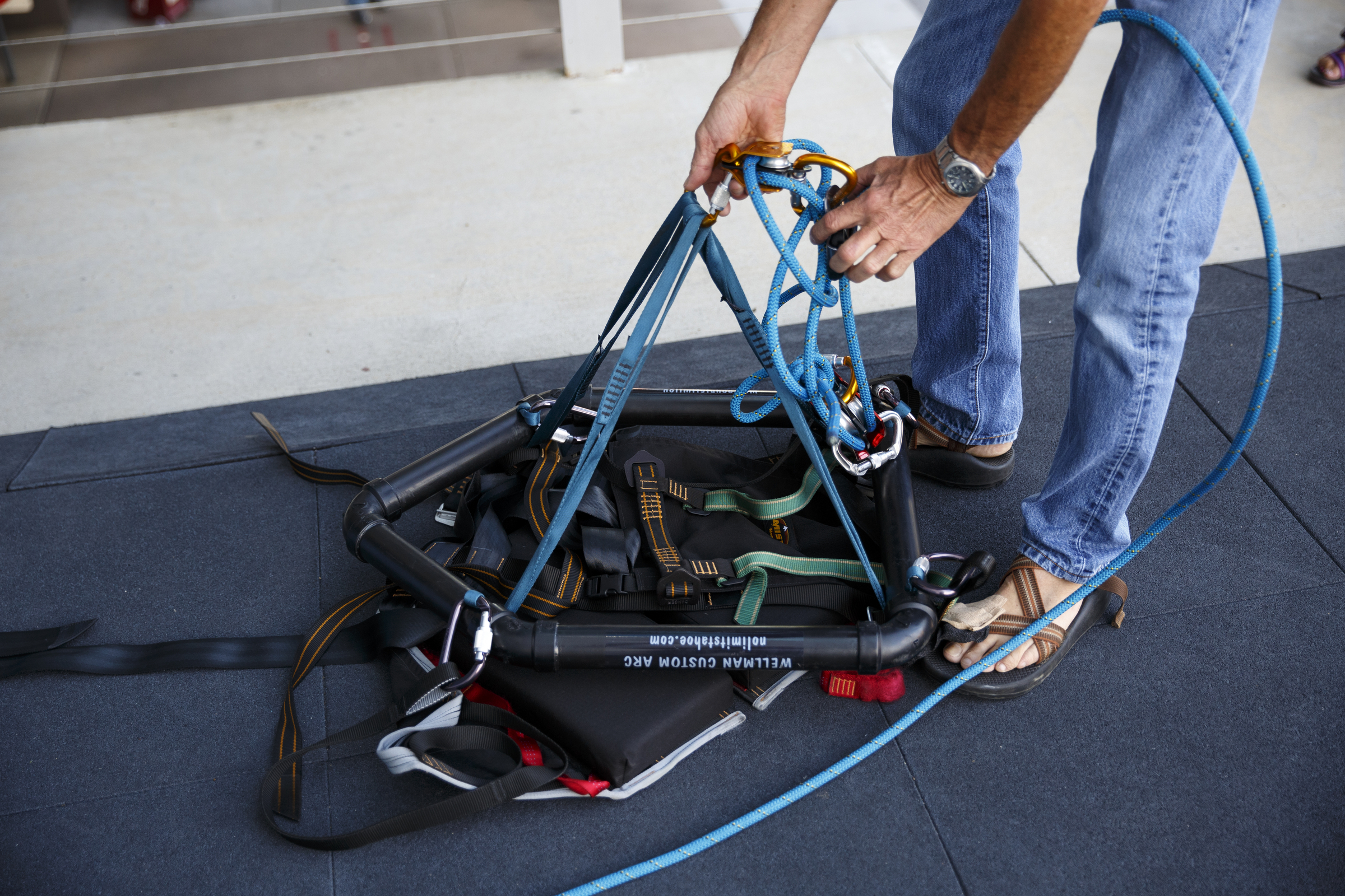 Fred Vail sets up a Wellman System harness, which allows climbers to ascend a wall without using their legs, before an adaptive climbing program at High Point Climbing gym Thursday, Sept. 17, 2015, in Chattanooga, Tenn. The program, which happens on the third Thursday of each month, provides resources to help disabled climbers enjoy the sport.