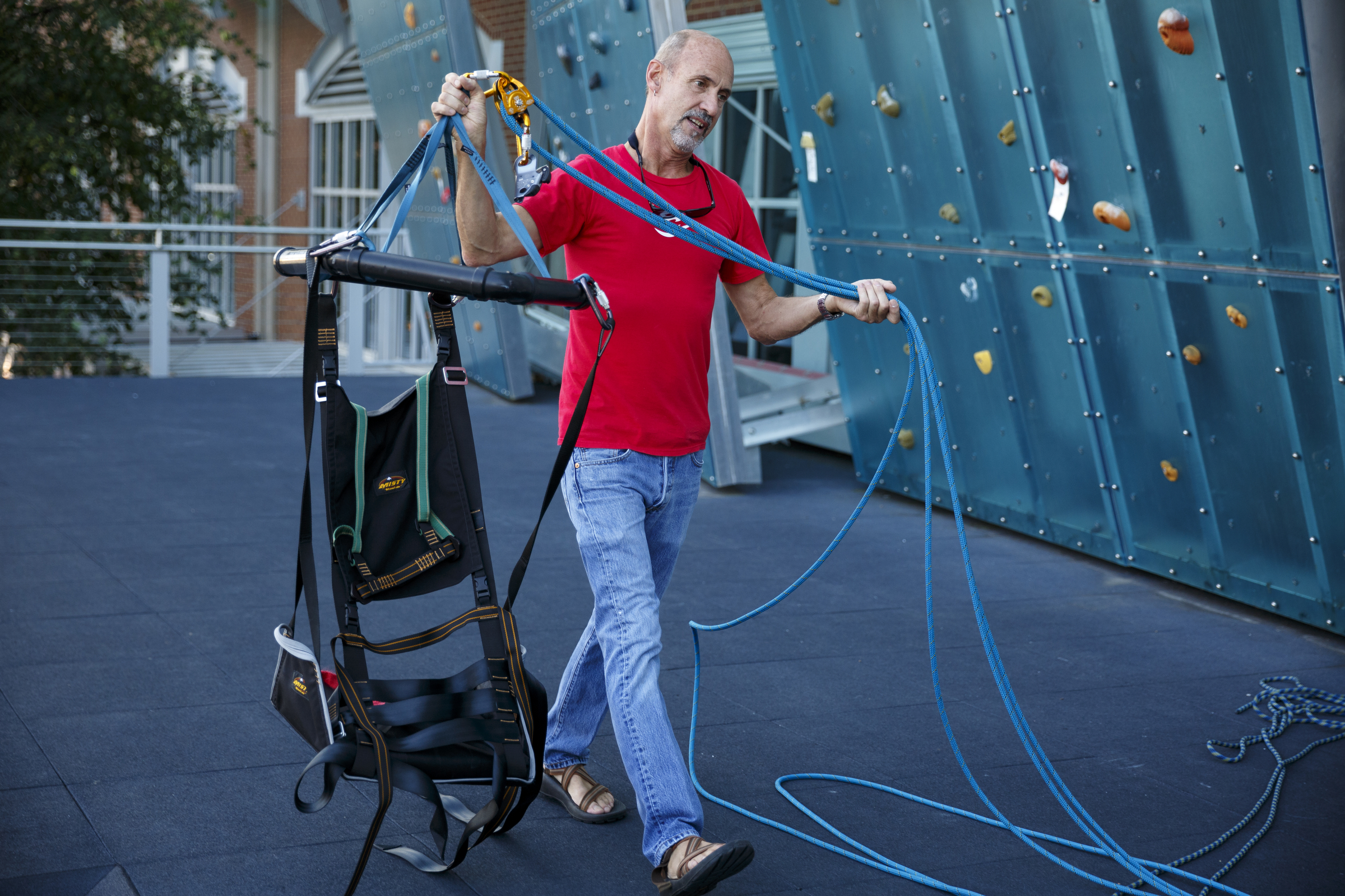 Fred Vail sets up a Wellman System harness, which allows climbers to ascend a wall without using their legs, before an adaptive climbing program at High Point Climbing gym Thursday, Sept. 17, 2015, in Chattanooga, Tenn. The program, which happens on the third Thursday of each month, provides resources to help disabled climbers enjoy the sport.