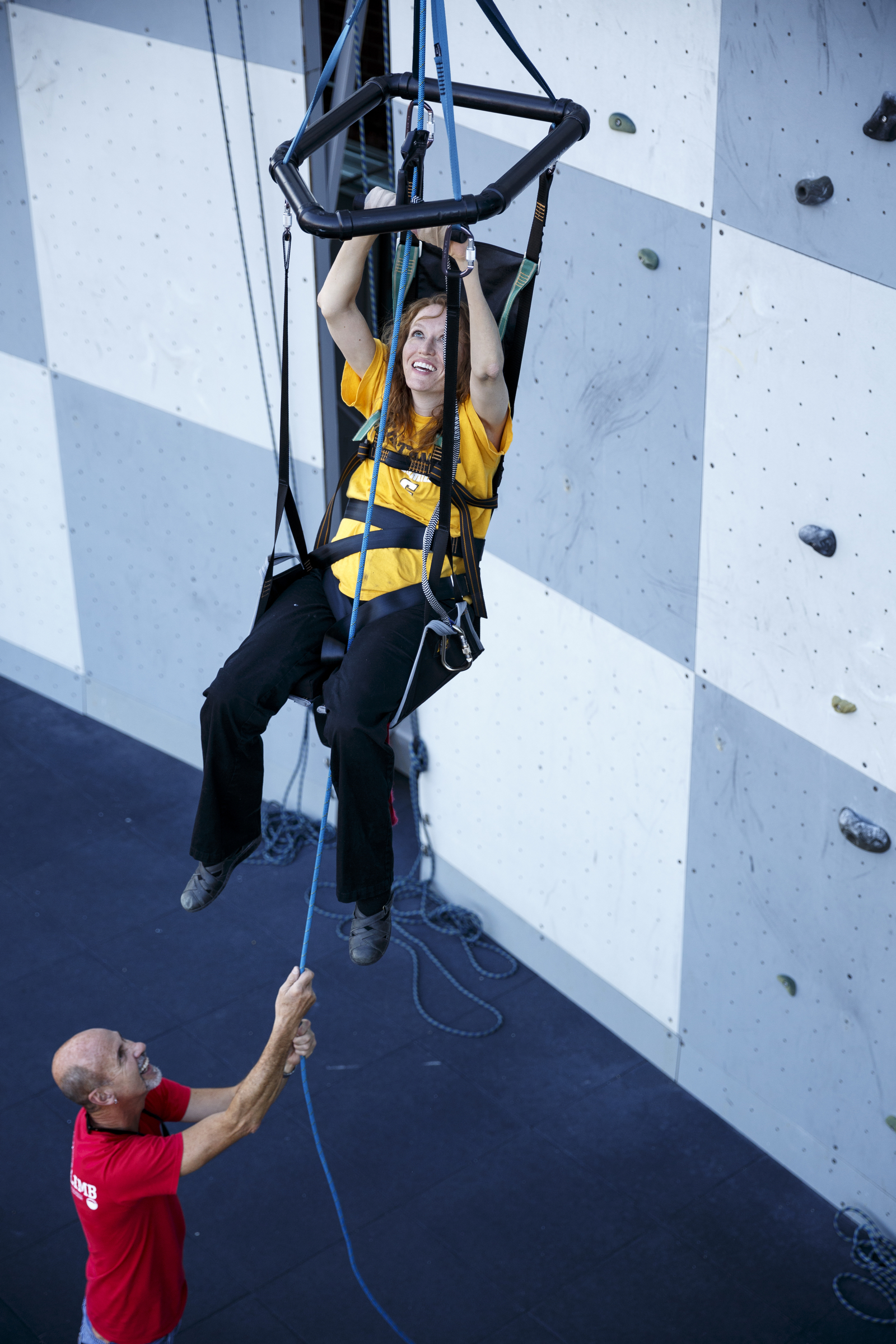 Fred Vail, left, holds a rope as Charity Trillet uses a Wellman System harness to ascend a wall without using her legs during an adaptive climbing program at High Point Climbing gym Thursday, Sept. 17, 2015, in Chattanooga, Tenn. The program, which happens on the third Thursday of each month, provides resources to help disabled climbers enjoy the sport.