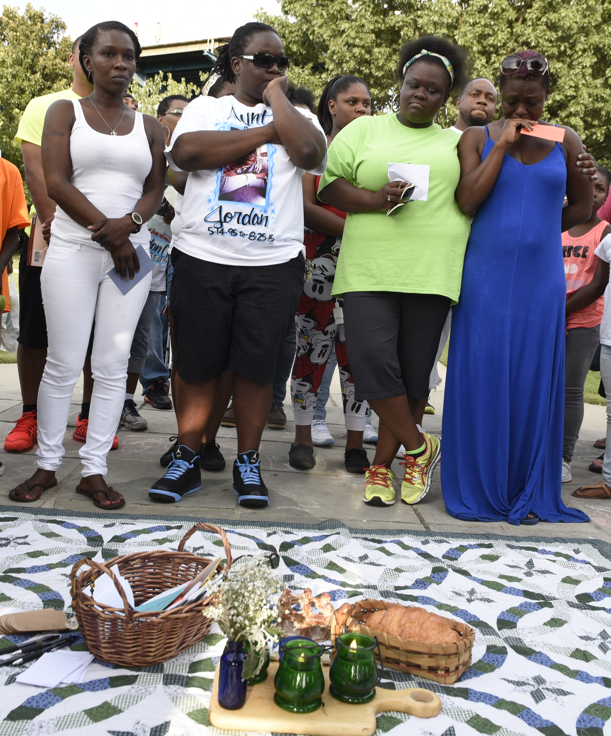 Relatives of Jordan Clark, killed during a Willow Street shooting on Aug. 25, stand together in Coolidge Park on Sunday, Sept. 20, 2015, in Chattanooga, Tenn., during an event in remembrance of families affected by violence. From left, are Clark's aunts, Natasha Smith, Murleana Smith and Ivy Smith, and Clark's mother, Satedra Smith.
