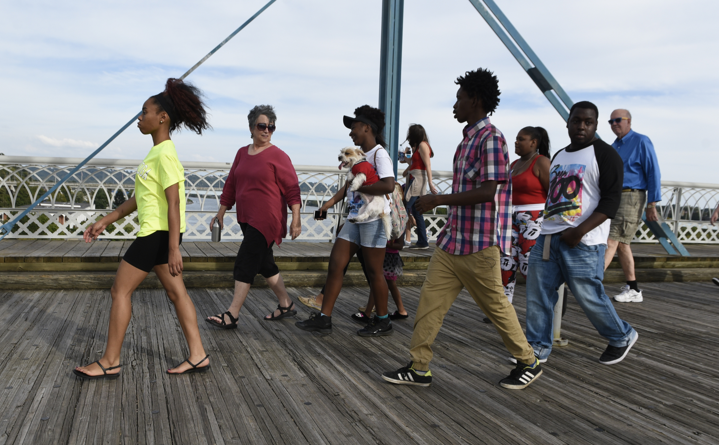 People cross the Walnut Street Bridge during a prayer walk on Sunday, Sept. 20, 2015, in Chattanooga, Tenn., in remembrance of families affected by violence.