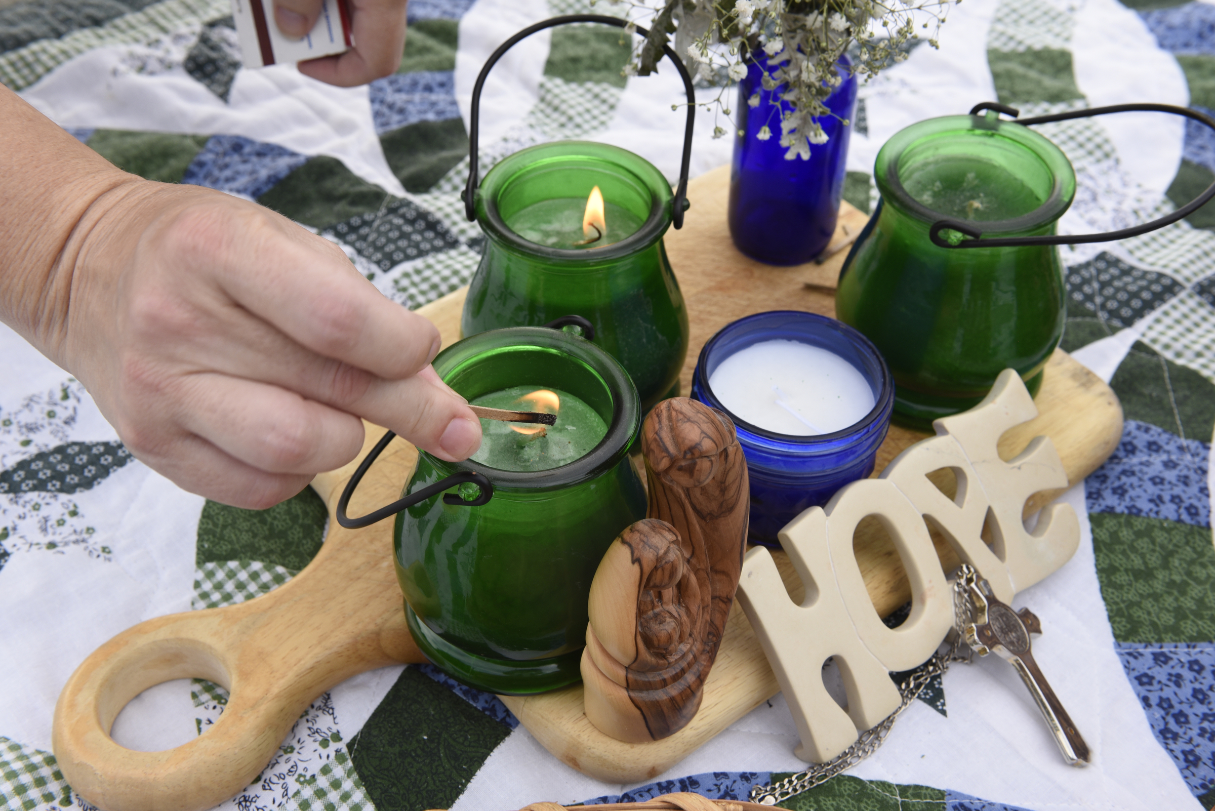 Rebecca Clark lights candles in Coolidge Park during a prayer walk on Sunday, Sept. 20, 2015, in Chattanooga, Tenn., in remembrance of families affected by violence.