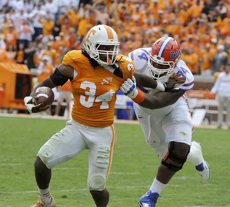 Tennessee linebacker Jalen Reeves-Maybin (34) is tackled by Florida offensive lineman Trenton Brown (74) during the second half of an NCAA college football game at Neyland Stadium, Saturday, Oct. 4, 2014, in Knoxville.