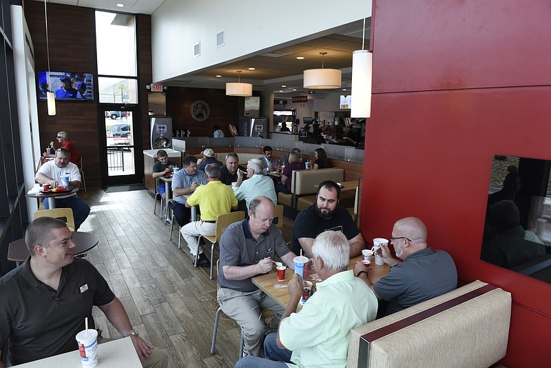 People eat in the dining room during the grand opening of the new Wendy's restaurant at 7408 Bonny Oaks Drive on Monday, Sept. 21, 2015, in Chattanooga, Tenn.