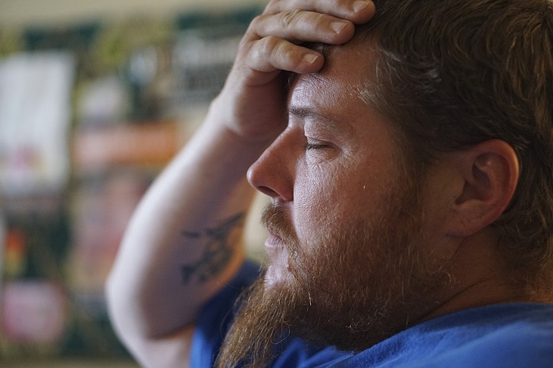 Staff Photo by Dan Henry / The Chattanooga Times Free Press- 9/21/15. Jerry Hogan, 35, takes a deep breath after receiving a check from Metropolitan Ministries on September 21, 2015 which will allow him to put a down payment on a rental home after he, his wife and three children were displaced from the condemned Superior Creek Lodge extended-stay motel. 