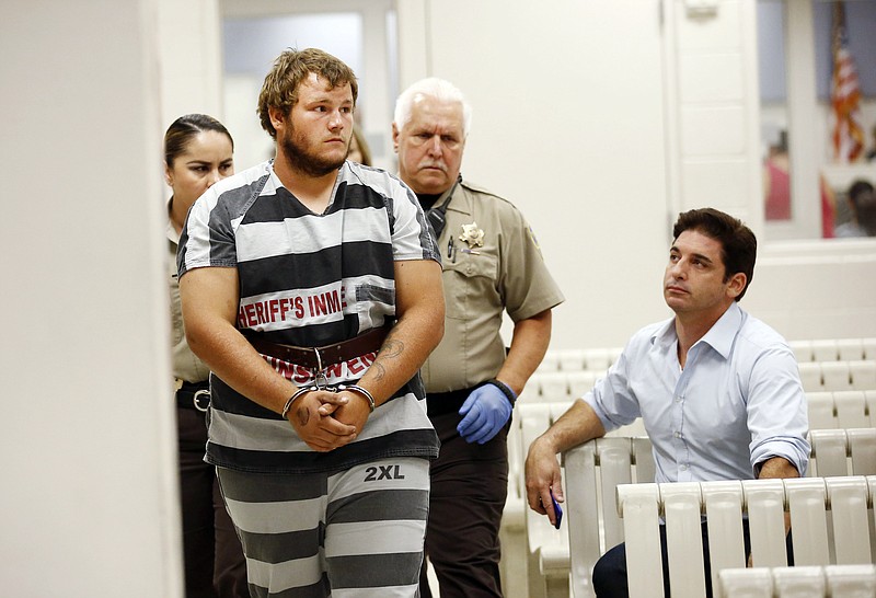 
              Leslie Allen Merritt Jr., makes his way to appear before a judge at the Maricopa County Sheriff's Office on Saturday, Sept. 19, 2015, in Phoenix. The landscaper is the suspect in a series of Phoenix freeway shootings and was arrested Friday after trying to sell a gun at a pawn shop.  (Rob Schumacher/The Arizona Republic via AP, Pool)
            